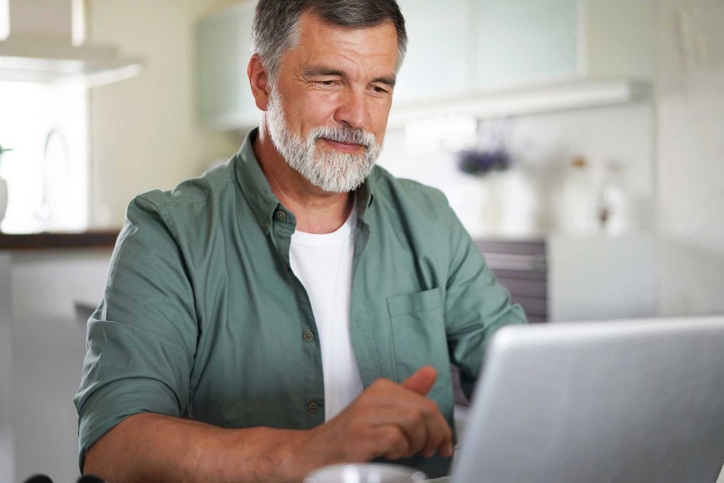 older man on laptop career reinvention